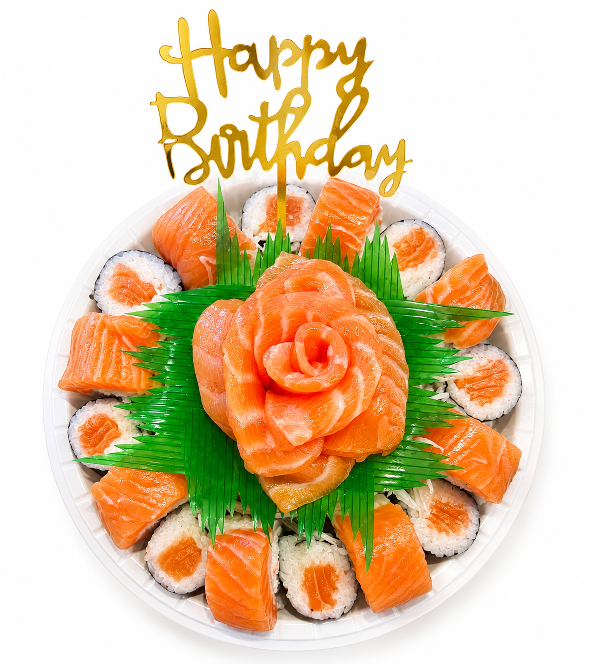 A round white plate filled with salmon sushi, arranged in a circular pattern with a green leaf garnish and a gold 'Happy Birthday' cake topper on a white background.