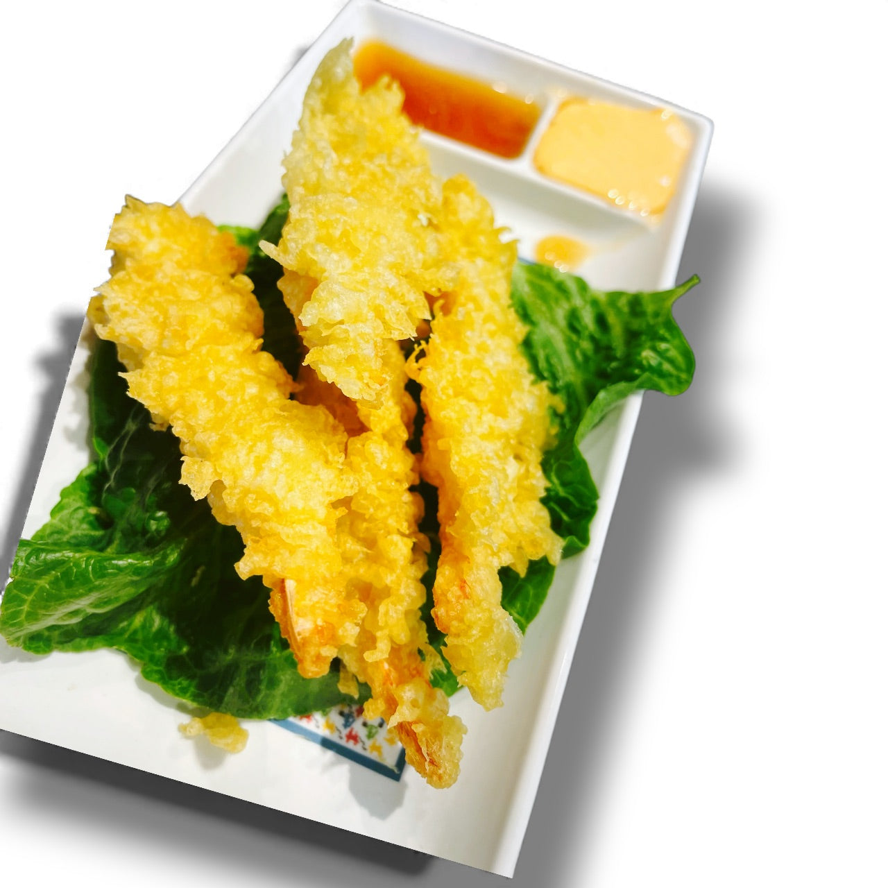 Fried tempura on a white plate with green leaves and two types of dipping sauces.