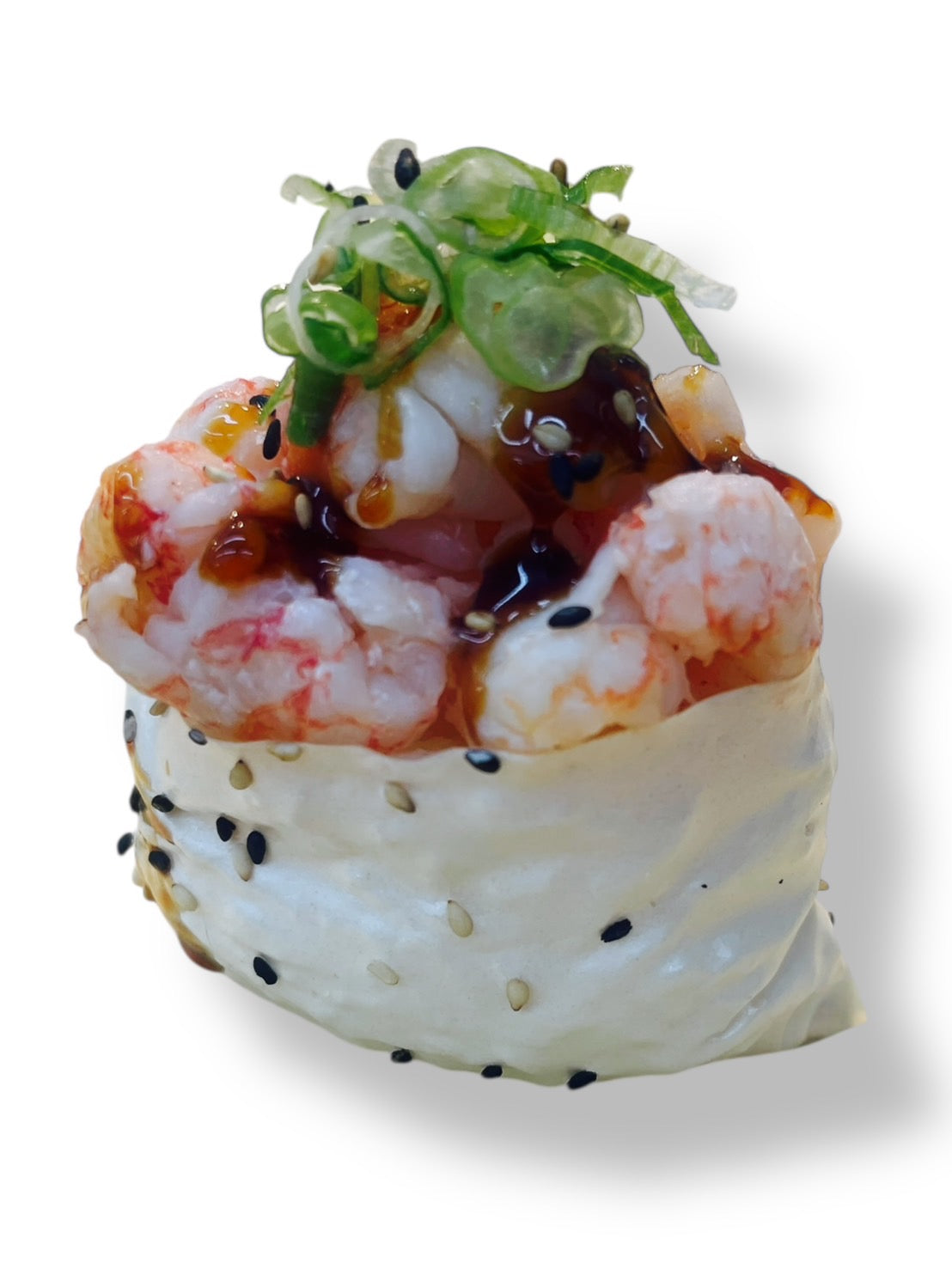 Baked lobster sushi topped with sweet eel glaze and fresh seaweed salad, wrapped with sesame-studded rice on a white background