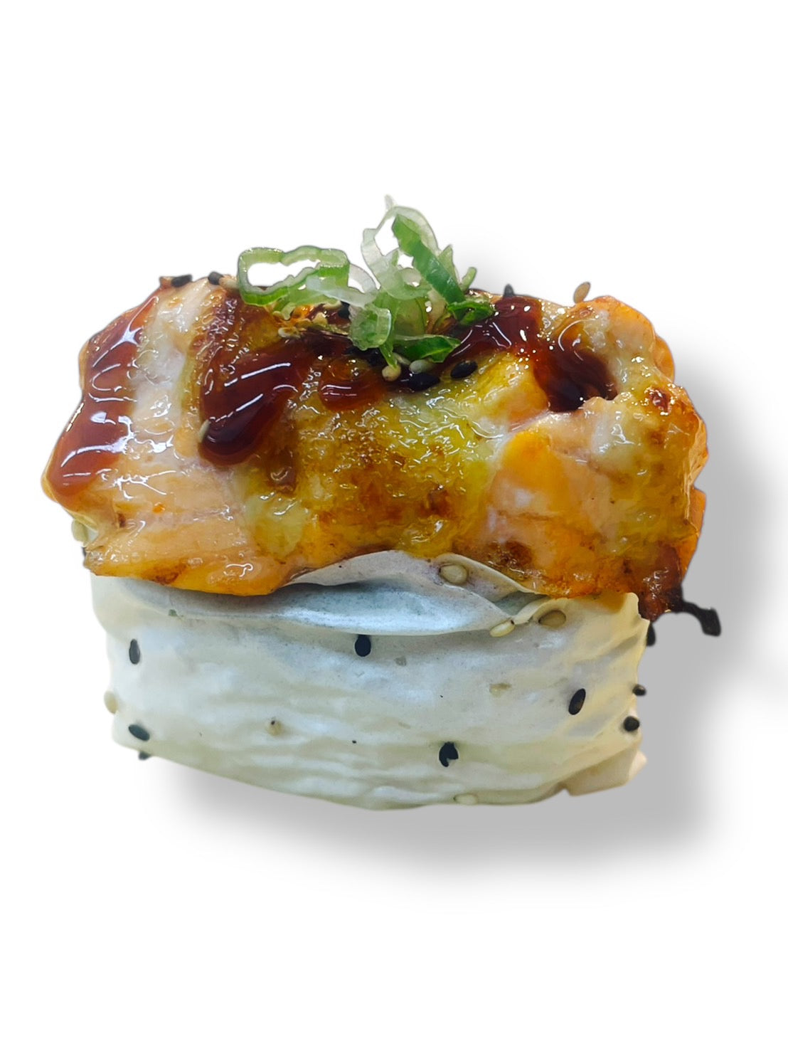 Baked salmon sushi topped with creamy sauce, sweet eel glaze, and sliced green onions, wrapped with sesame-studded rice on a white background