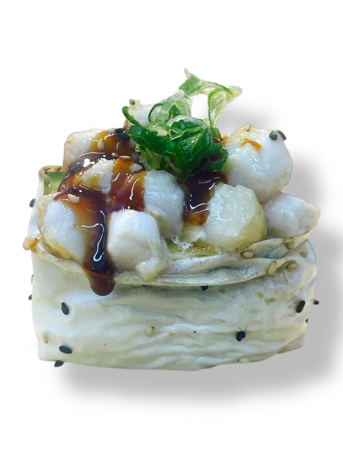 Baked scallop sushi topped with creamy sauce, sweet eel glaze, and fresh seaweed salad, wrapped with sesame rice on a white background