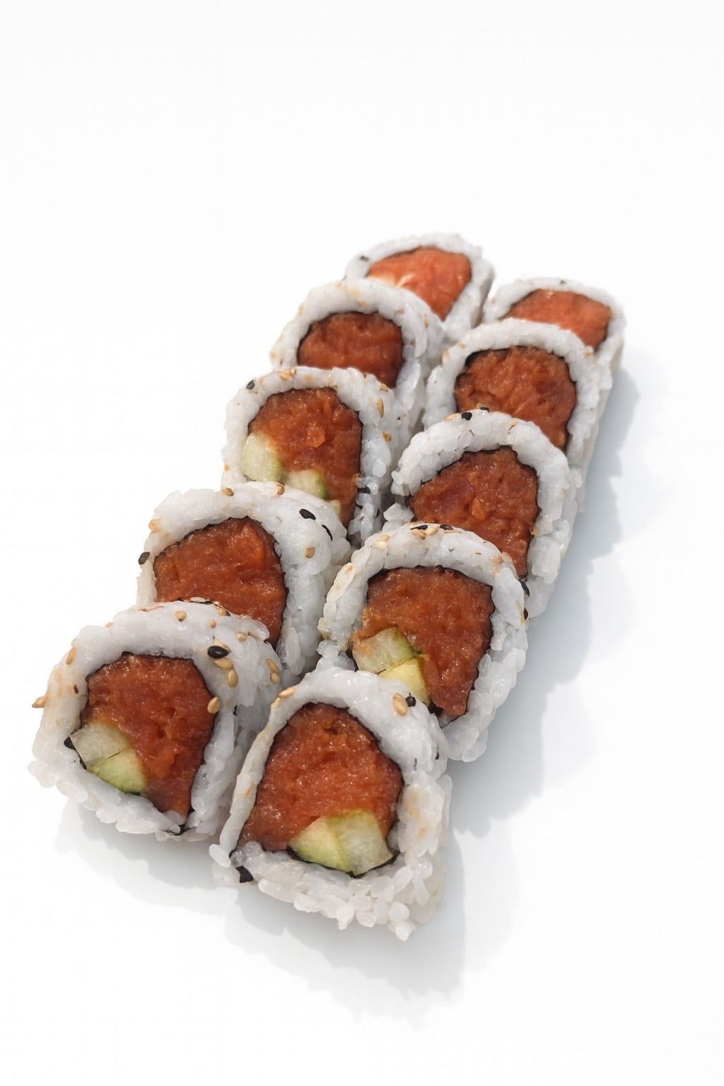 Roll of sushi with spicy tuna and cucumber on a white background