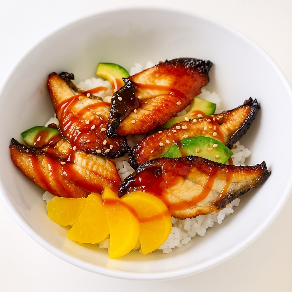 Bowl of sushi with fish, avocado, and mango on a white background